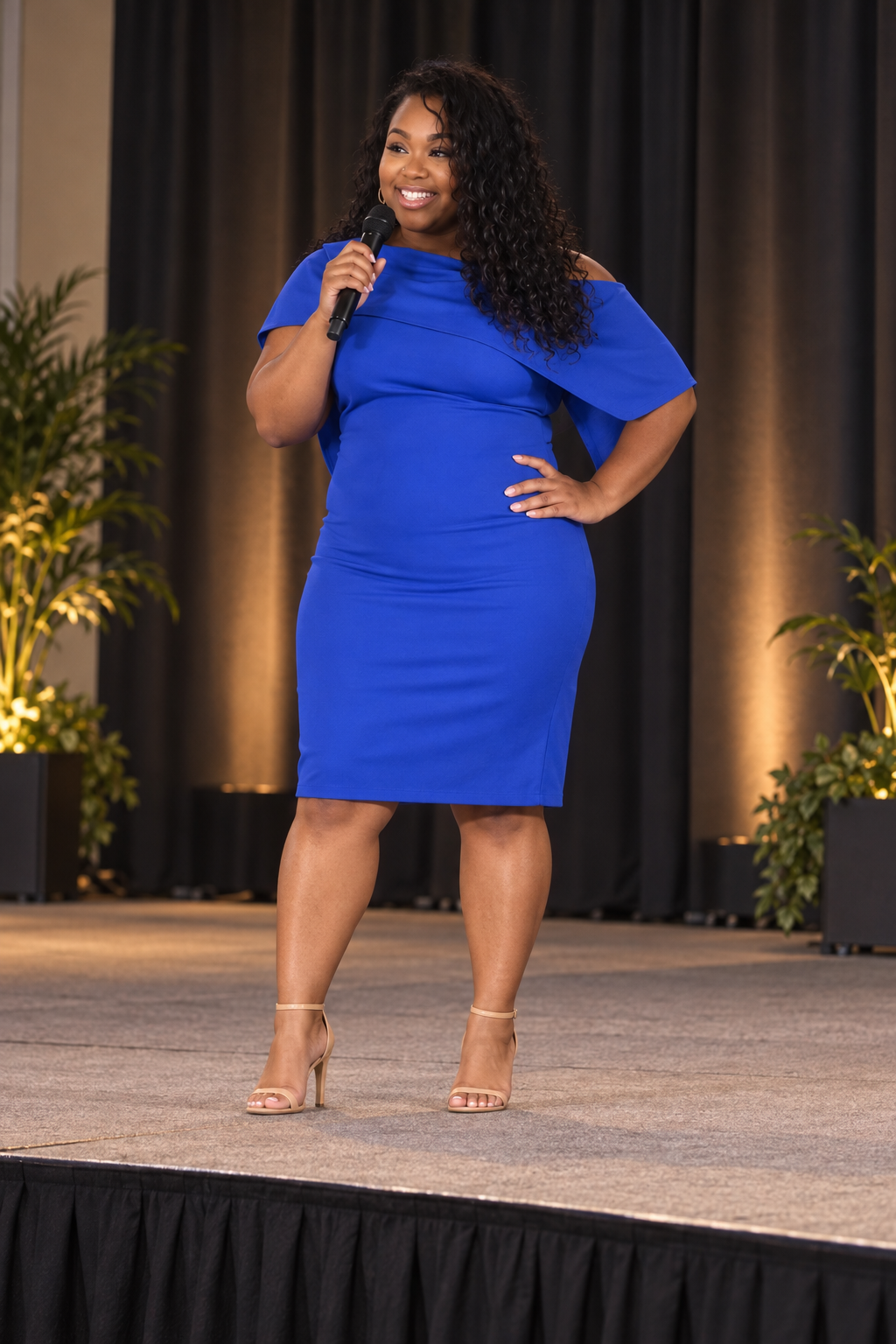 Erika on stage with a microphone